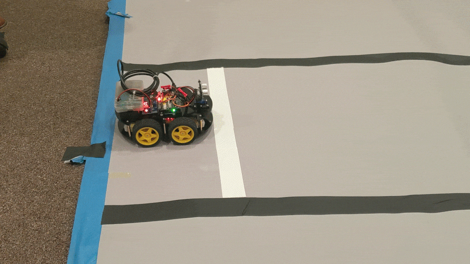 The path is marked in black tape, with a white line marking the starting point