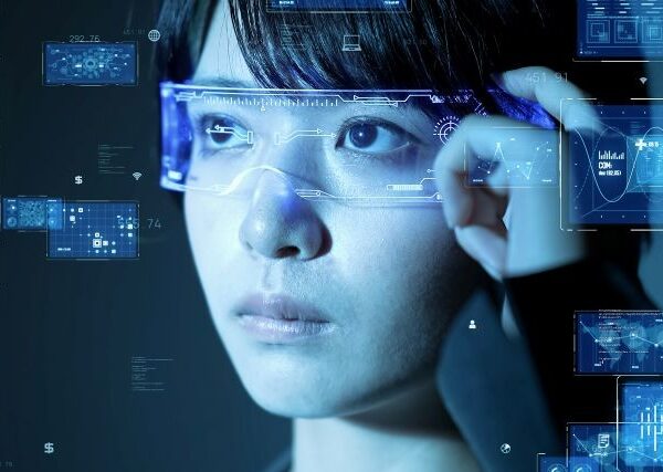 A dark-haired Asian woman wears smart glasses, Charts and data in rectangles overlay the image, simulating information she can see using the wearables