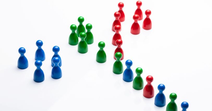 Clusters of red, green, and blue pegs join a line that mixes the colors together.
