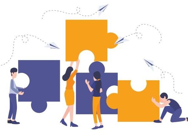 Four figures dressed in purple and gold cooperate to align four puzzle pieces, also purple and gold, against a white background with paper airplanes flying overhead