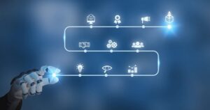 Against a blue background, a robotic hand points to a string of icons, which represent the people, tools, and governance needed to roll out AI integration successfully