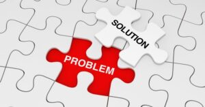 A white jigsaw puzzle is missing one piece. The gap is red, with the word 'problem' centered. A white piece, labeled 'solution,' rests alongside the gap.
