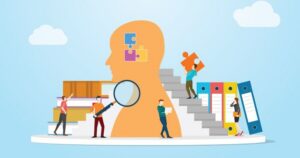 Against a light-blue background with floating clouds, a team of small people work around a large head, searching for information, loading knowledge from books, and carrying information in the shape of puzzle pieces into the brain.