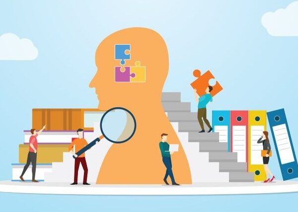 Against a light-blue background with floating clouds, a team of small people work around a large head, searching for information, loading knowledge from books, and carrying information in the shape of puzzle pieces into the brain.