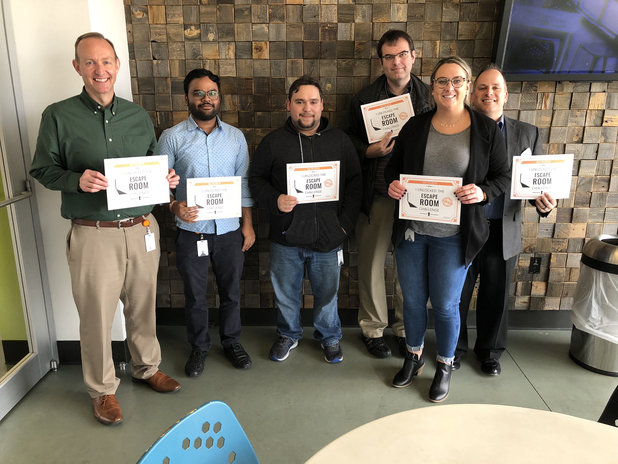 Employees with their certificates