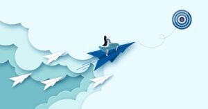 A cartoon woman rides a paper-airplane rocket, leading 4 other 'rockets' up, toward a target