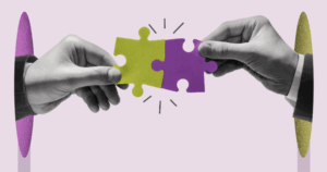 Two hands holding connected puzzle pieces